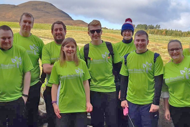 Group of fundraisers in Anne Rowling T-shirts with hills in background