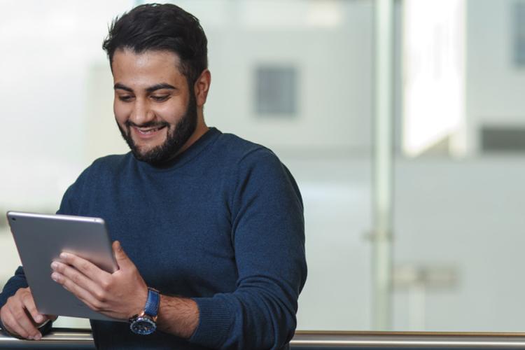 A person happily scrolling through an iPad