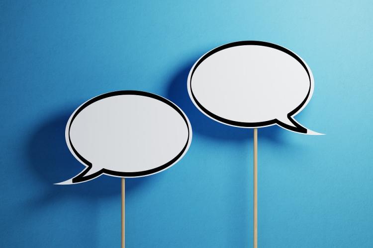 Speech bubbles on sticks on a blue gradient background