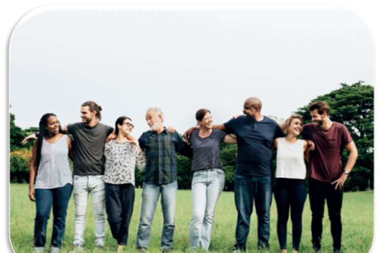 a diverse group of people in a park standing together in a line