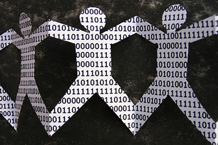 A paper chain of cut out figures, with each figure filled with binary code