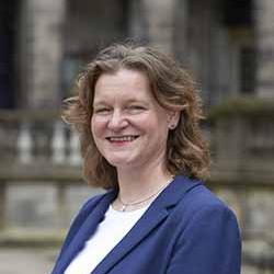 A portrait picture of Chloe Kippen outside the University of Edinburgh's Old College