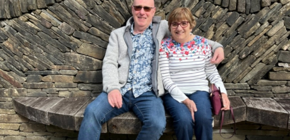 Picture of David and Helen Taylor on an ornate dry-stone bench