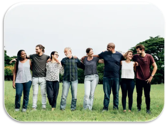 a diverse group of people in a park standing together in a line